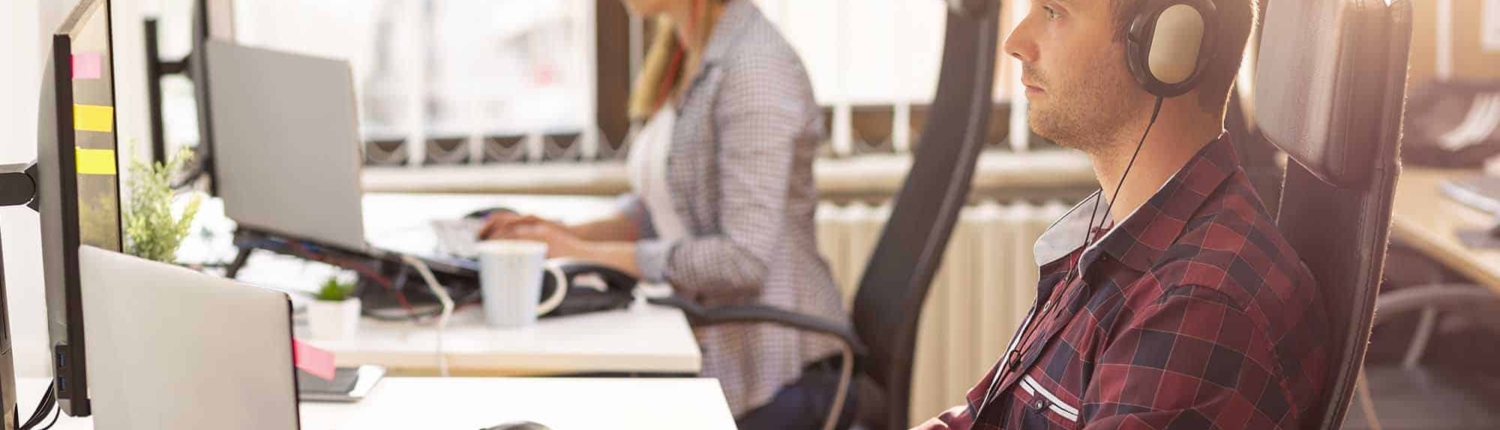 two workers sitting at desk working