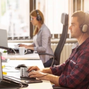 two workers sitting at desk working