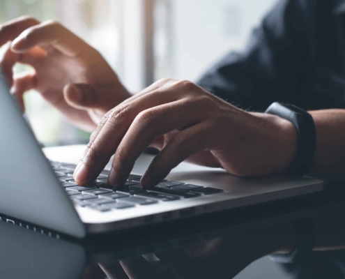 Man on computer researching electric liens