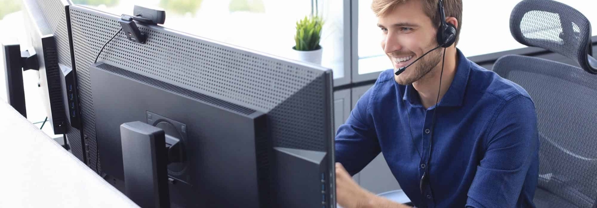 Guy sitting at desk while talking on headset