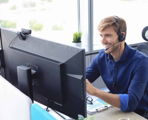 Guy sitting at desk while talking on headset