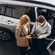 woman speaking to saleswoman at dealership