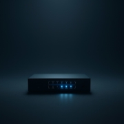 Managed IT Infrastructure Stabili... Minimalist network switch with glowing blue lights symbolizing managed IT services for small businesses and reliable technology infrastructure.